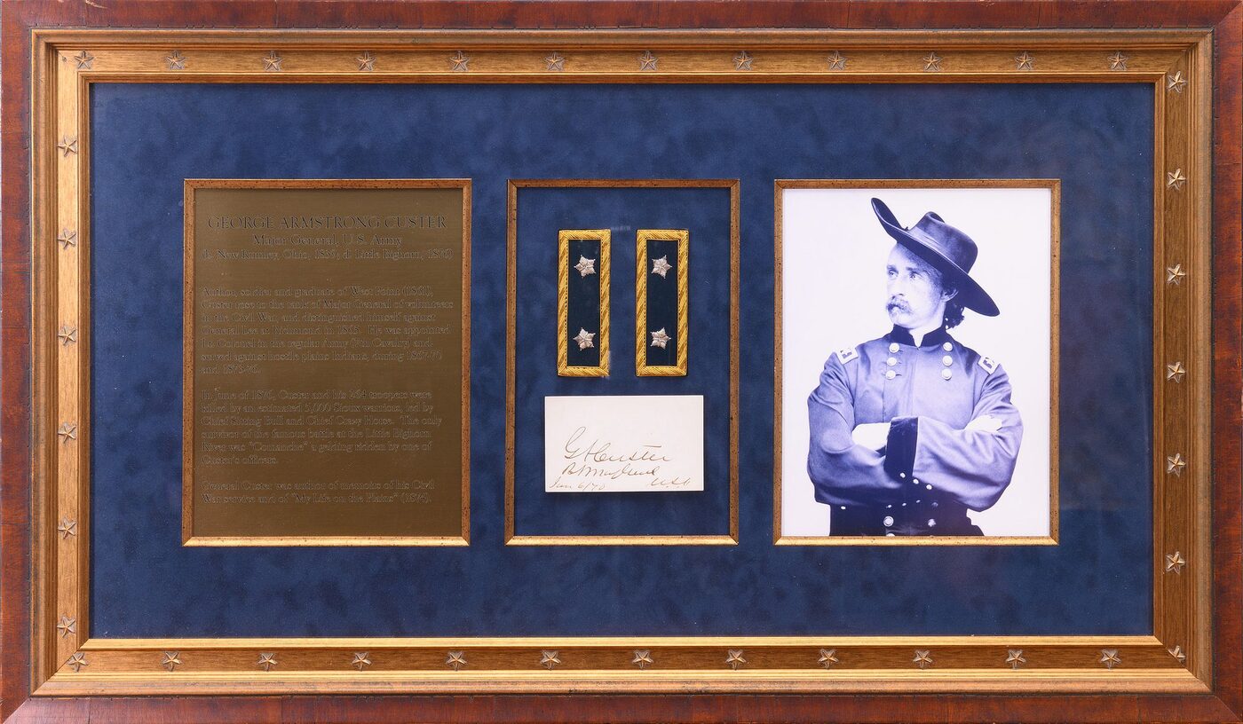 Framed display with a pair of Major General's epaulettes, a clipped Custer signature and a portrait of Custer