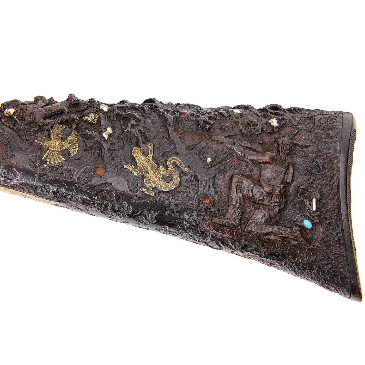 Detail of the carved shoulder stock with inlaid figures in high relief